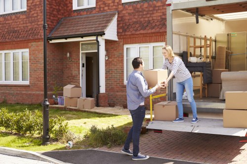 Removal van and moving boxes in a Romford residential street
