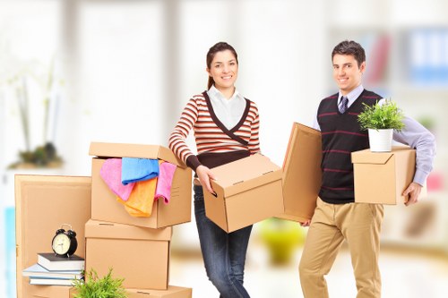 Professional movers carrying furniture during a Romford house move