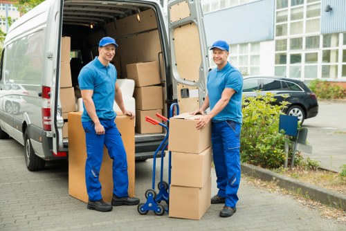 Movers carrying items through a Romford house with care