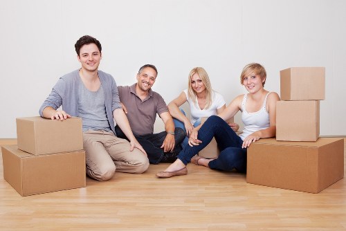 Local movers carrying furniture near Romford homes